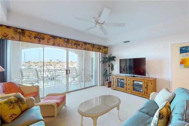 5540 N Harbor Village Dr Unit 204, Vero Beach, FL 32967 - living room with carpet, a ceiling fan, plenty of natural light, and a raised ceiling