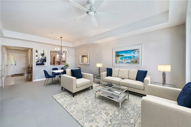 5540 N Harbor Village Dr Unit 204, Vero Beach, FL 32967 - living area featuring a chandelier, carpet floors, a raised ceiling, and a ceiling fan