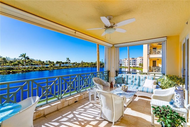 exterior space with ceiling fan and a water view