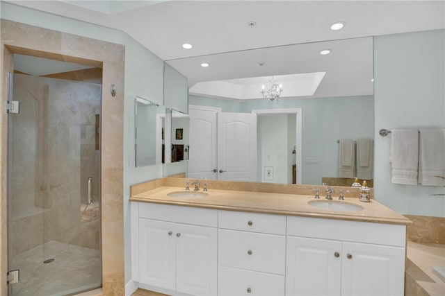 full bathroom with double vanity, recessed lighting, a stall shower, and a sink