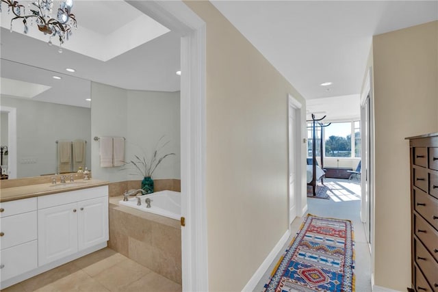 full bathroom featuring tile patterned floors, recessed lighting, a bath, and vanity