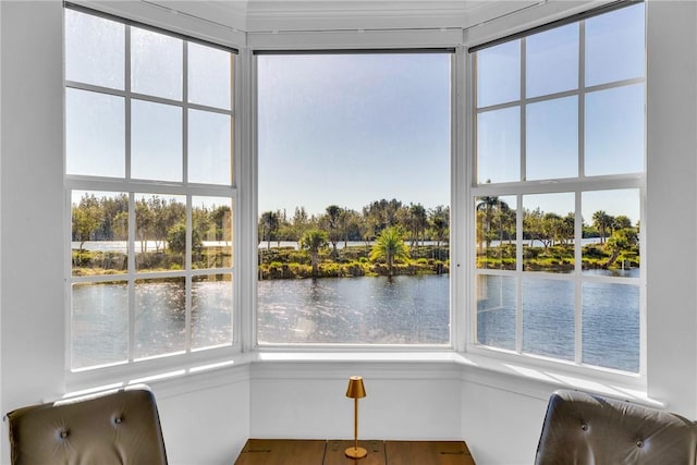 unfurnished sunroom with a water view