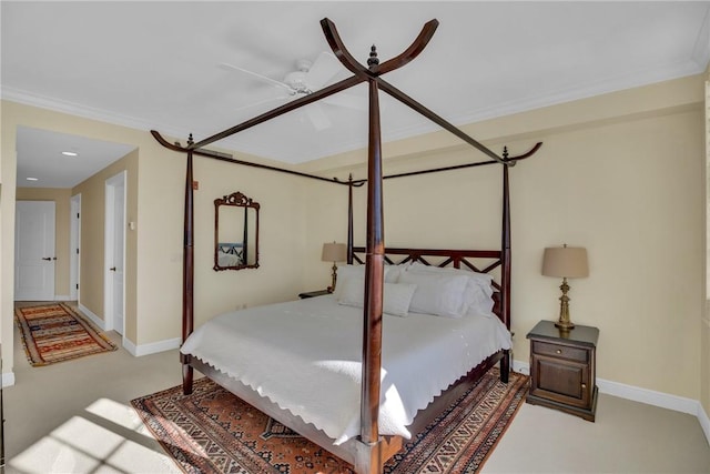 carpeted bedroom featuring a ceiling fan, baseboards, and ornamental molding