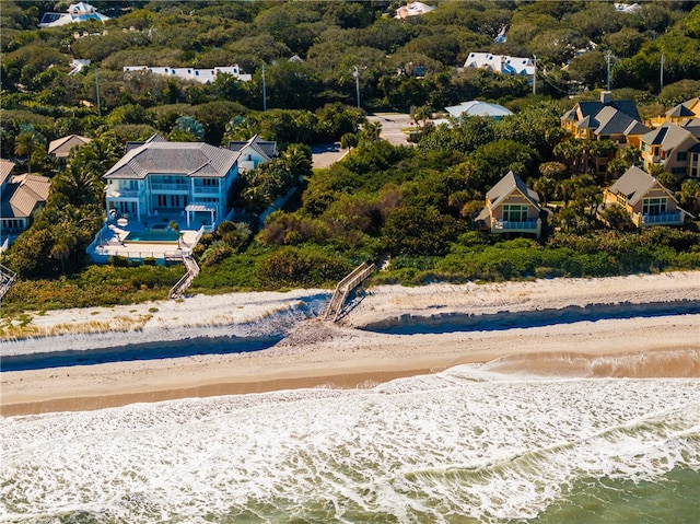 birds eye view of property with a view of the beach and a water view