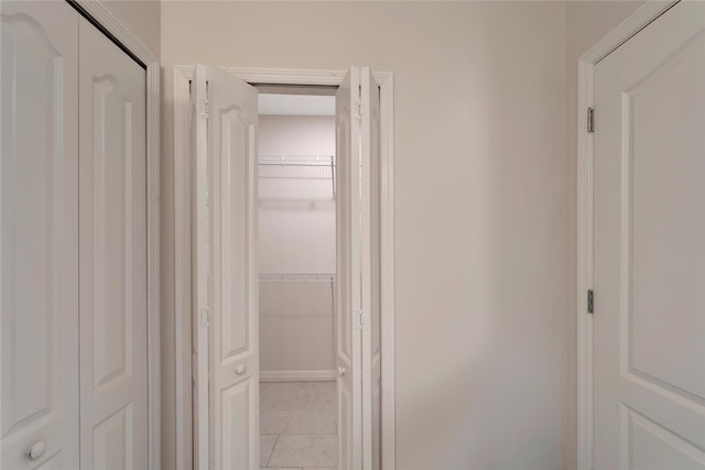 hall featuring light tile patterned floors