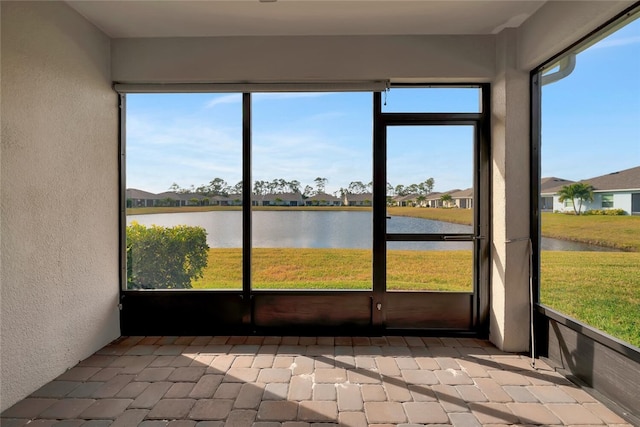 unfurnished sunroom with a water view and a healthy amount of sunlight