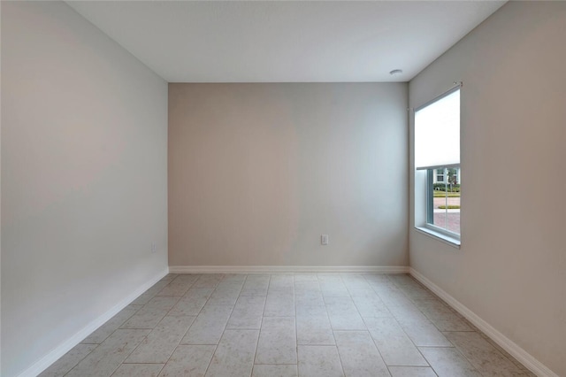 unfurnished room featuring baseboards