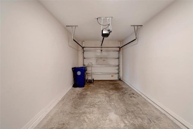 garage featuring baseboards and a garage door opener