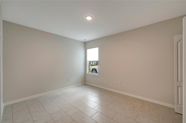 unfurnished room with baseboards