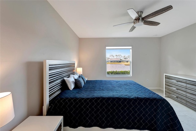 bedroom with ceiling fan and baseboards