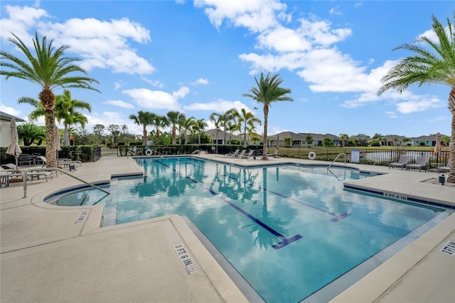 pool featuring fence and a patio