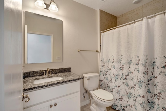 bathroom with curtained shower, vanity, and toilet