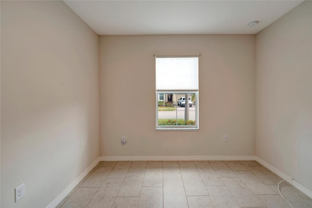 spare room featuring baseboards