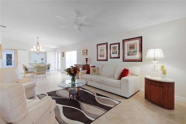 tiled living room featuring ceiling fan with notable chandelier and lofted ceiling