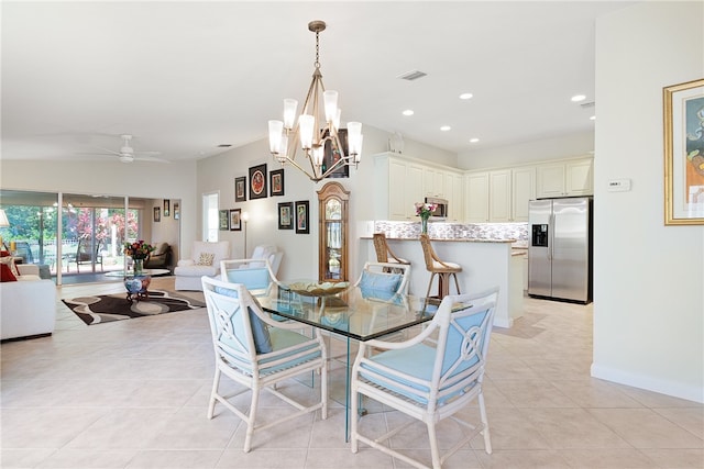 tiled dining space featuring ceiling fan with notable chandelier