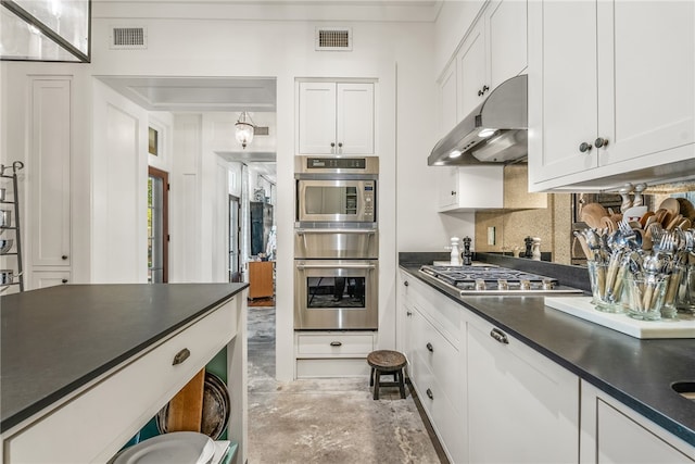 kitchen featuring tasteful backsplash, white cabinets, and stainless steel appliances