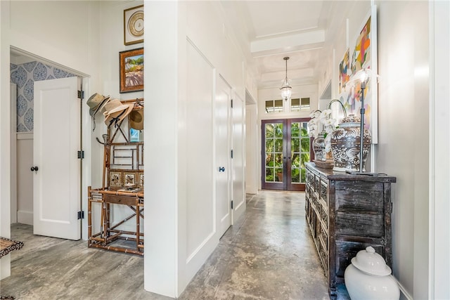 hall featuring french doors and concrete flooring