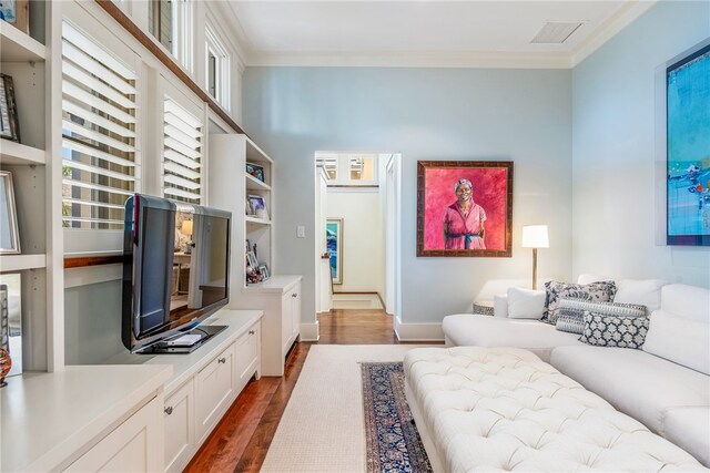 living room with dark hardwood / wood-style floors and ornamental molding