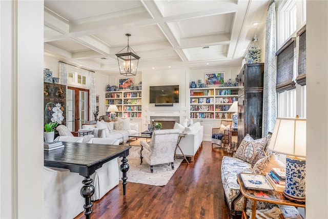 living room featuring a healthy amount of sunlight, beamed ceiling, dark hardwood / wood-style floors, and coffered ceiling