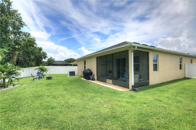 240 Barbossa Dr, Sebastian, FL 32958 - fenced backyard featuring a sunroom and an outdoor fire pit