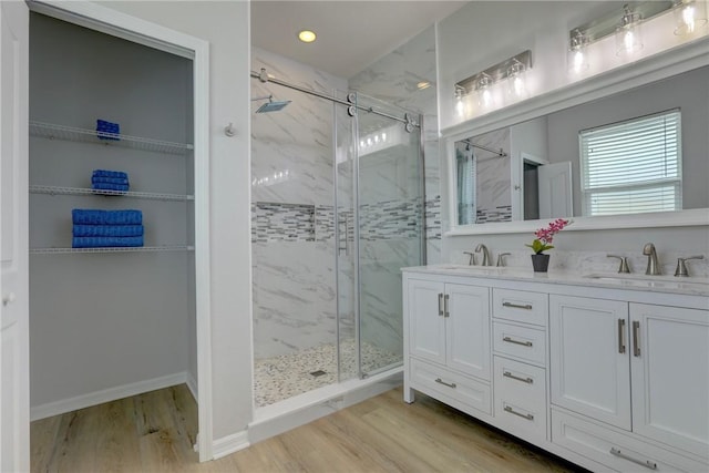 240 Barbossa Dr, Sebastian, FL 32958 - full bath featuring a marble finish shower, wood finished floors, double vanity, and recessed lighting