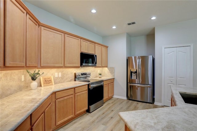 240 Barbossa Dr, Sebastian, FL 32958 - kitchen with appliances with stainless steel finishes, light wood-style flooring, tasteful backsplash, recessed lighting, and light brown cabinets