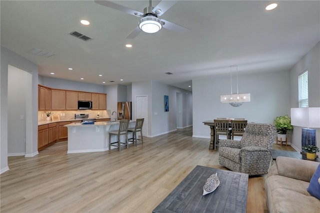 240 Barbossa Dr, Sebastian, FL 32958 - living area with light wood-type flooring, recessed lighting, ceiling fan, and a chandelier