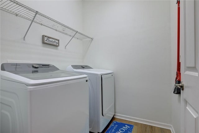 240 Barbossa Dr, Sebastian, FL 32958 - laundry room featuring independent washer and dryer and wood finished floors