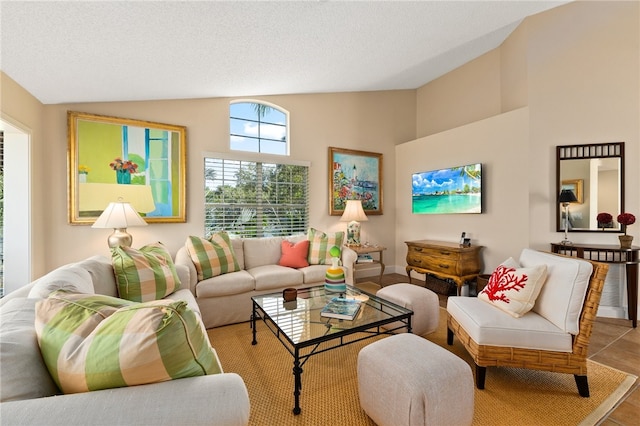 tiled living room featuring a textured ceiling and lofted ceiling