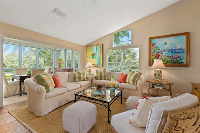 living room featuring light tile patterned floors, a textured ceiling, and vaulted ceiling