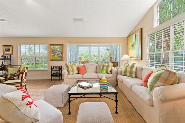 tiled living room featuring plenty of natural light and lofted ceiling