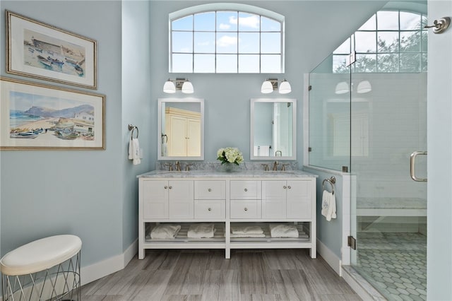 bathroom with a towering ceiling, vanity, hardwood / wood-style flooring, and walk in shower