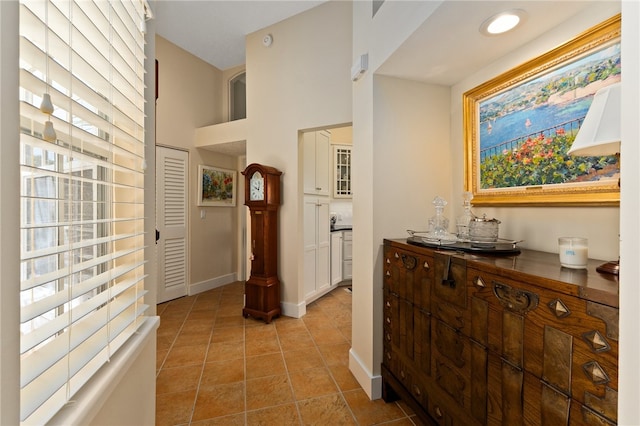 hallway featuring plenty of natural light and light tile patterned floors