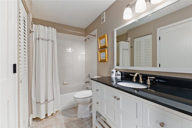 full bathroom with vanity, shower / bath combo, a textured ceiling, and toilet