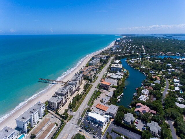 drone / aerial view featuring a view of the beach and a water view