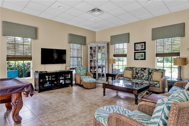 tiled living room with a paneled ceiling and pool table