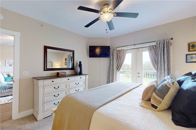 bedroom featuring access to exterior, light carpet, french doors, and ceiling fan