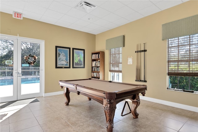 rec room with a wealth of natural light, light tile patterned floors, billiards, and french doors