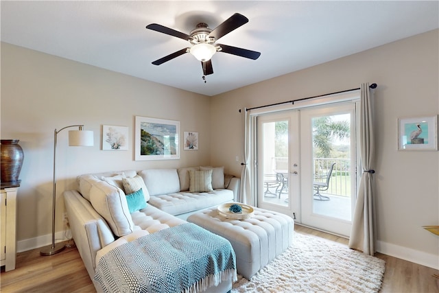 living room featuring ceiling fan, french doors, and light hardwood / wood-style flooring