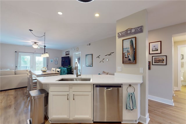 kitchen with ceiling fan, sink, pendant lighting, dishwasher, and white cabinetry