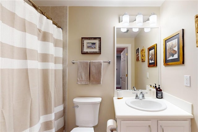 bathroom with a shower with shower curtain, vanity, and toilet