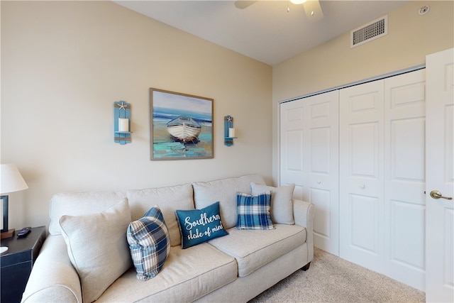 living room featuring light carpet and ceiling fan