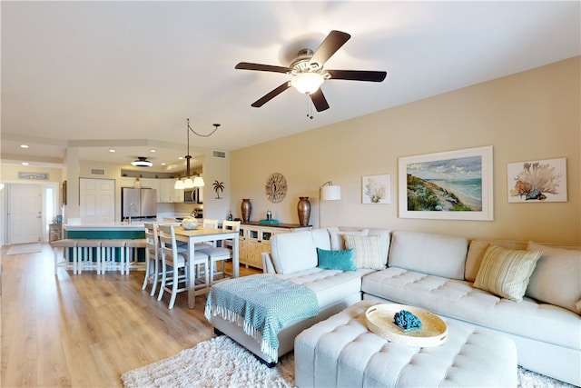 living room featuring light hardwood / wood-style floors and ceiling fan