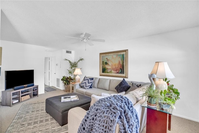 living room featuring visible vents, ceiling fan, carpet, and a textured ceiling