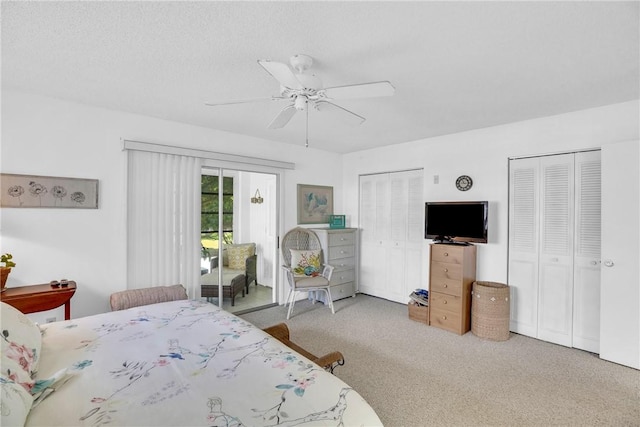 carpeted bedroom with multiple closets, ceiling fan, and access to outside