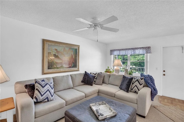 living room with a textured ceiling and ceiling fan