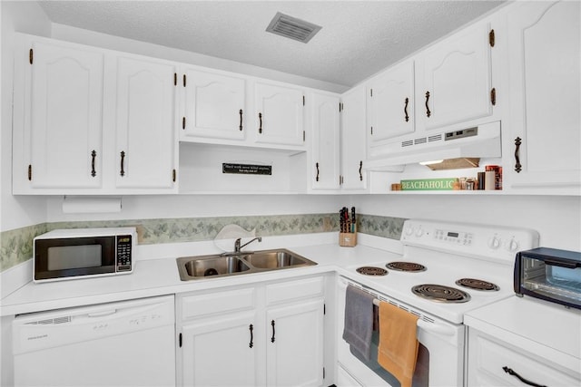 kitchen featuring a sink, white cabinetry, under cabinet range hood, white appliances, and visible vents