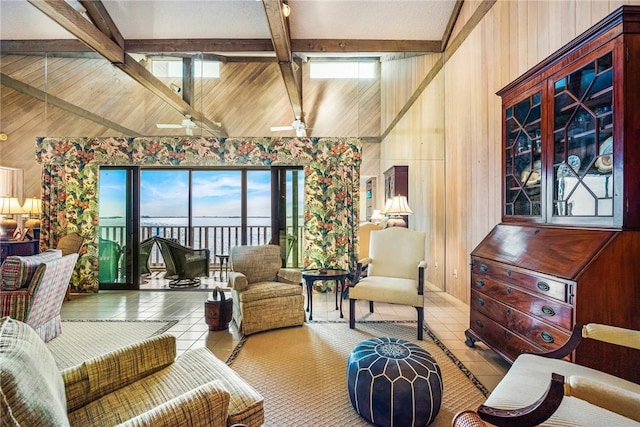 tiled living room with ceiling fan, wood walls, and lofted ceiling with beams