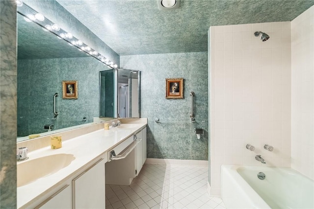 bathroom featuring tile patterned floors, vanity, and tiled shower / bath