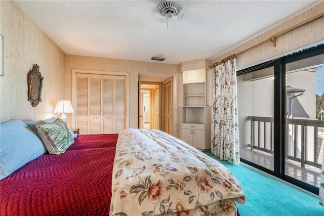 carpeted bedroom with a textured ceiling, a closet, and access to outside